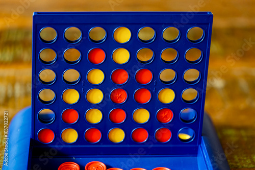 Strategy game Four wins with yellow and red chips for two people.
