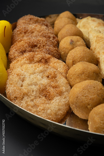 Indian sweets in a plate includes anarsa, shakkarpara morichoor  Bundi Laddu, Gujiya or Karanji for diwali celebration photo