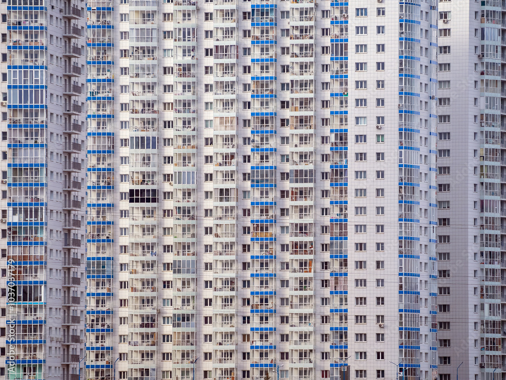 Huge number of windows on a large panel system building. Urban pattern Huge number of windows on a large panel system building. Urban pattern