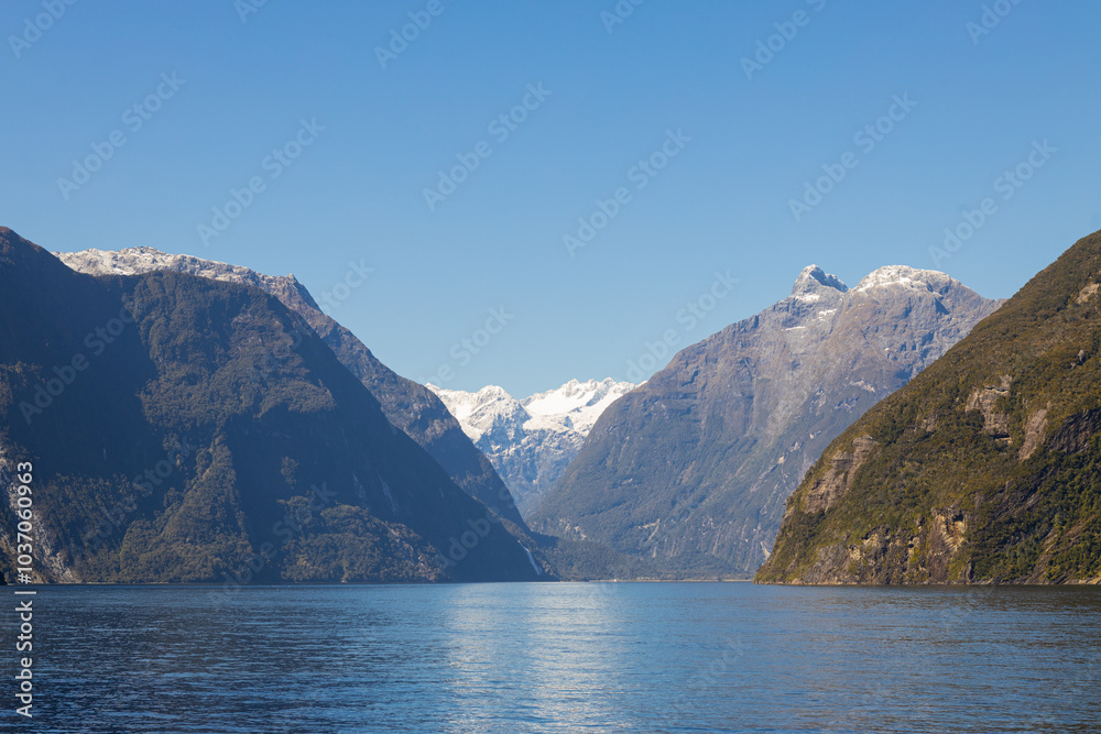Milford sound fjord reflecting on sunny day with clear sky Milford sound fjord reflecting on sunny day with clear sky