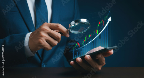 Businessman holding a magnifying glass analyze upward trend stock chart with smartphone.