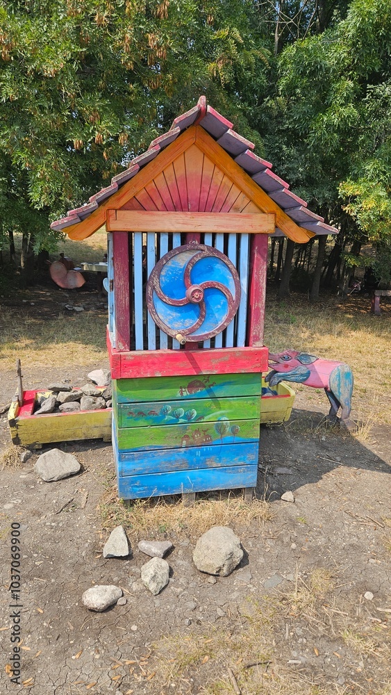 Obraz premium Colorful outdoor shrine with religious iconography in a natural setting