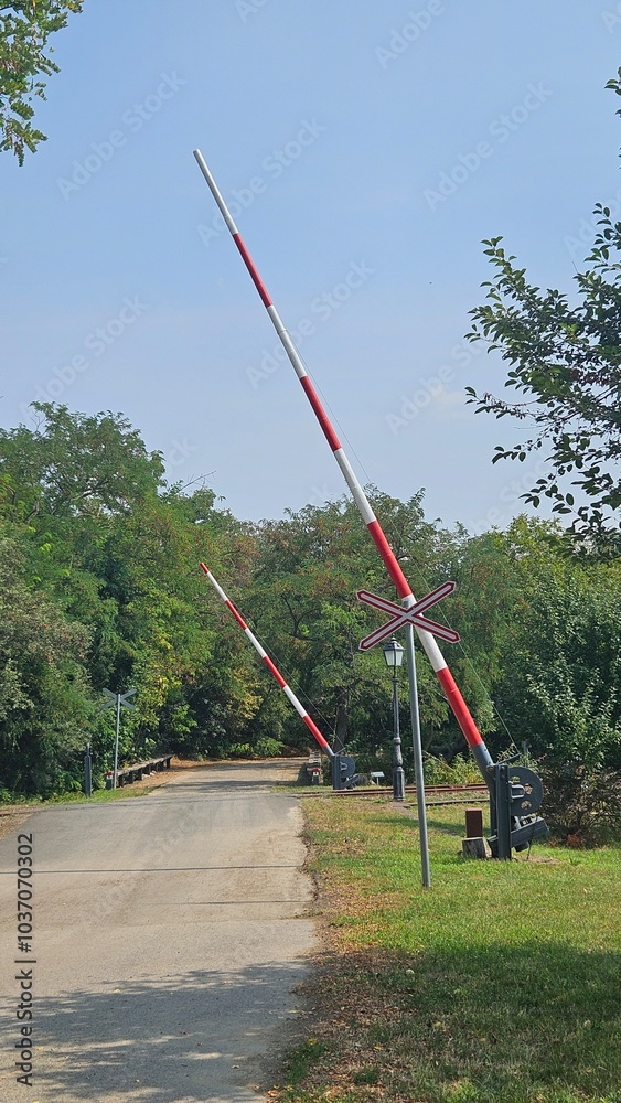 Fototapeta premium Open railway crossing gate in a quiet rural area