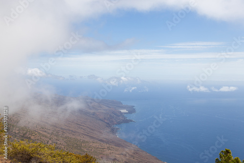 Clouds rolling over volcanic coastline on el hierro, canary islands