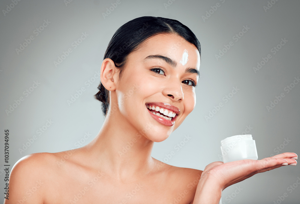 Face cream, skincare and portrait of woman in studio with nourishment, hydration and glow. Happy, health and female person from Cuba with moisturizer for facial dermatology routine by gray background Face cream, skincare and portrait of woman in studio with nourishment, hydration and glow. Happy, health and female person from Cuba with moisturizer for facial dermatology routine by gray background