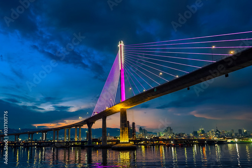 Cebu City, Philippines - CCLEX bridge illuminated at night, reflecting vibrant colors over the water.