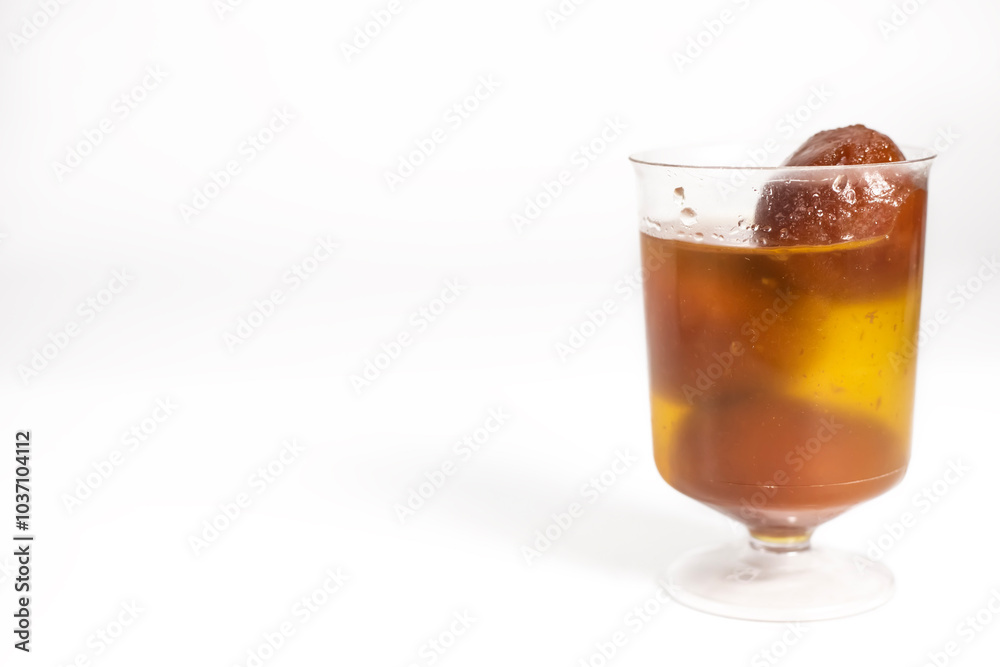 Gulab Jamun in sugar syrup in a transparent glass cup. Gulab Jamun in sugar syrup in a transparent glass cup.