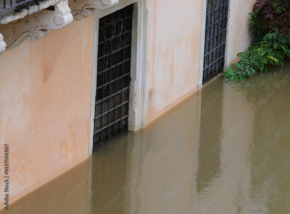 Φωτογραφία wall and windows of the house are submerged by the muddy river water after the o