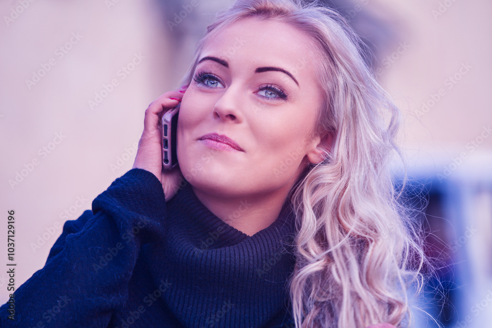 Blonde woman talking on smartphone and smiling Blonde woman talking on smartphone and smiling