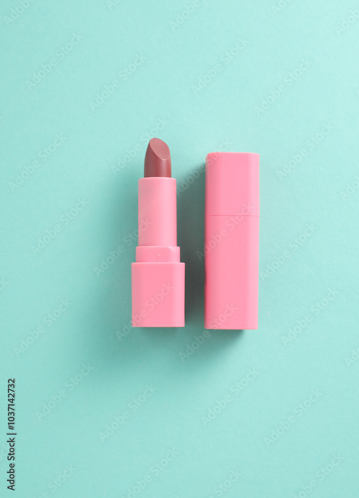 Tube of pink lipstick on mint green background Tube of pink lipstick on mint green background