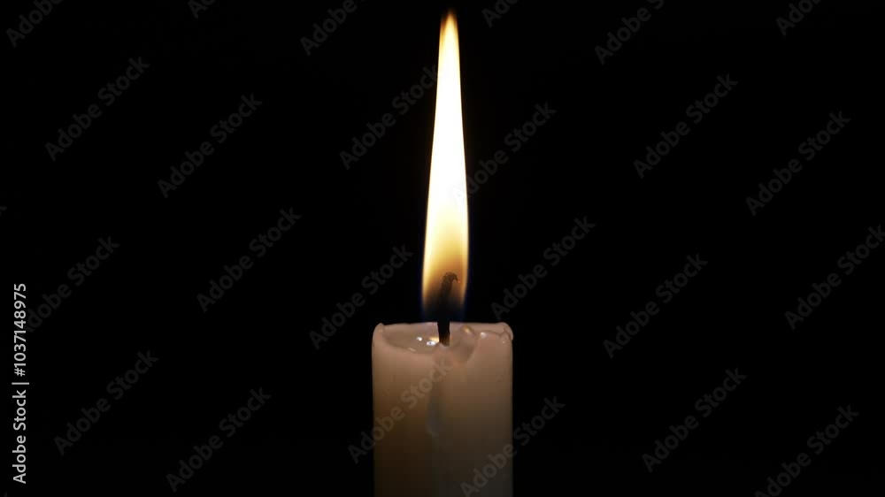 A single candle burns brightly in the dark, symbolizing sorrow and remembrance. This moment captures the essence of a heartfelt religious ceremony honoring loss and grief. A single candle burns brightly in the dark, symbolizing sorrow and remembrance. This moment captures the essence of a heartfelt religious ceremony honoring loss and grief.
