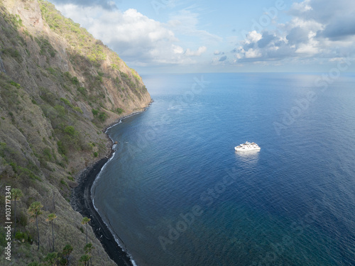 The scenic and rugged coastline of the island of Komba lies 70 km north of the Lesser Sunda Islands of Indonesia. This remote island, surrounded by reef, is an active volcano that often erupts. photo