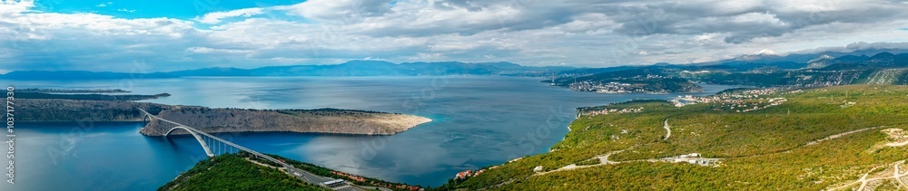 Aerial panorama view of Adriatic Sea, Krk Bridge, Krk island, mountains in the distance. Croatia travel Aerial panorama view of Adriatic Sea, Krk Bridge, Krk island, mountains in the distance. Croatia travel
