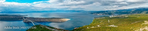 Aerial panorama view of Adriatic Sea, Krk Bridge, Krk island, mountains in the distance. Croatia travel 