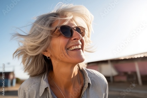 Portrait of a beautiful blond woman with short hair and sunglasses.