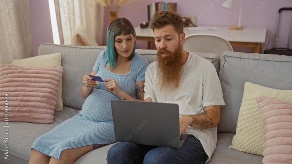 Pregnant woman and bearded man with tattoos using laptop and credit card on couch in cozy living room, indicating online shopping or financial planning. Pregnant woman and bearded man with tattoos using laptop and credit card on couch in cozy living room, indicating online shopping or financial planning.