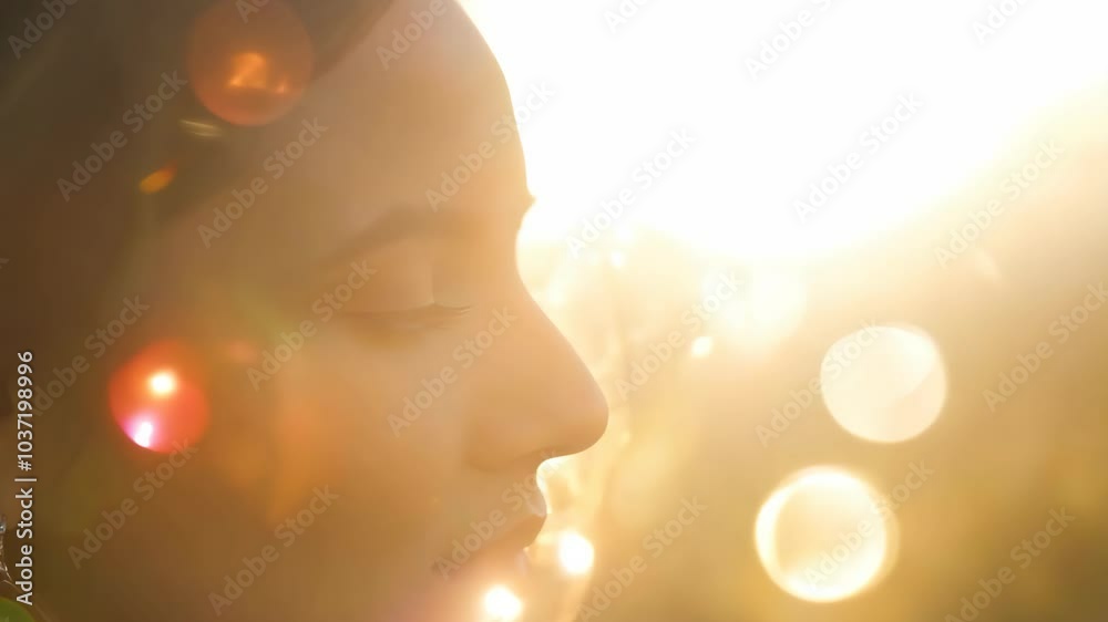 Serene woman in sunlit glow with lens flare bokeh effect Serene woman in sunlit glow with lens flare bokeh effect
