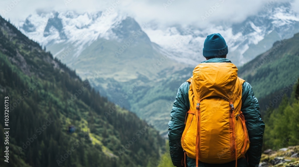 Hiker with Backpack in the Snow-Capped Mountains Hiker with Backpack in the Snow-Capped Mountains