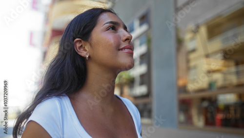 Smiling brunette woman enjoying her walk along a lively urban street in a latin city Free Download Smiling brunette woman enjoying her walk along a lively urban street in a latin city - GFXLoad