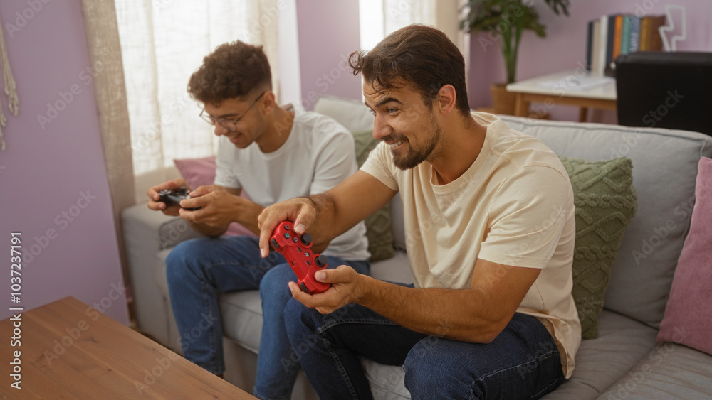 Father and son playing video games together in a cozy living room, displaying love and bonding between the two men at home Father and son playing video games together in a cozy living room, displaying love and bonding between the two men at home