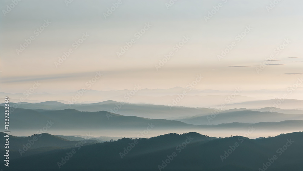 Obraz premium Serene Mountain Range at Sunrise with Soft Light and Shadows