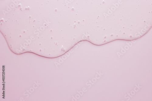 Liquid cosmetic minimal pink background, flowing gel texture, dripping jelly cream or face serum beauty product photo