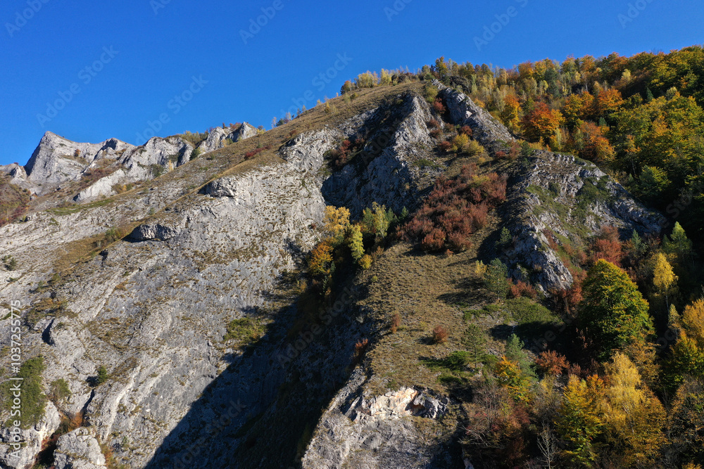 Aerial view of rocky limestone mountains and autumn forest Aerial view of rocky limestone mountains and autumn forest