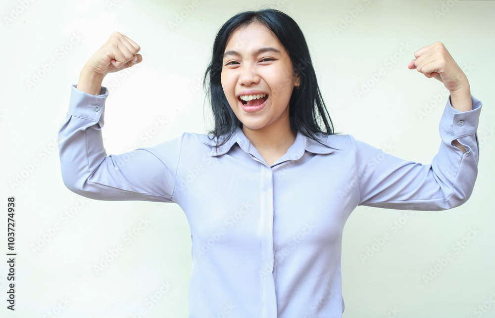 carefree powerful asian young business woman laughing at camera with raising arms showing muscle strength, proud of self achievement, wearing formal shirt standing over white background carefree powerful asian young business woman laughing at camera with raising arms showing muscle strength, proud of self achievement, wearing formal shirt standing over white background
