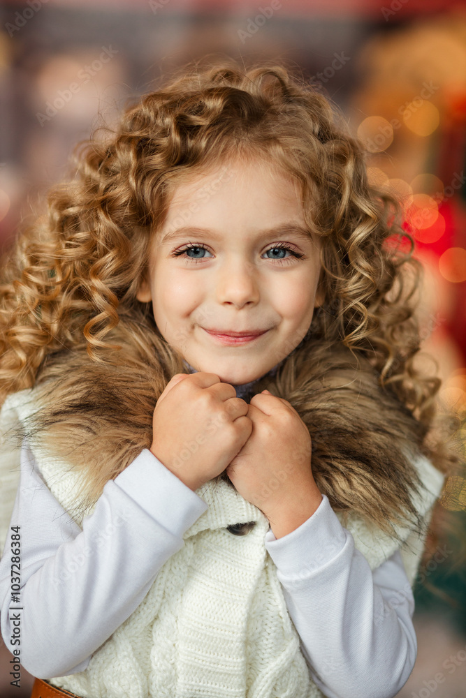 Happy New Year and Christmas. portrait of a little curly girl dressed in white clothes on the background of a New Year's interior with a beautifully decorated Happy New Year and Christmas. portrait of a little curly girl dressed in white clothes on the background of a New Year's interior with a beautifully decorated