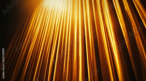 A low angle view of a golden curtain with light shining through it.