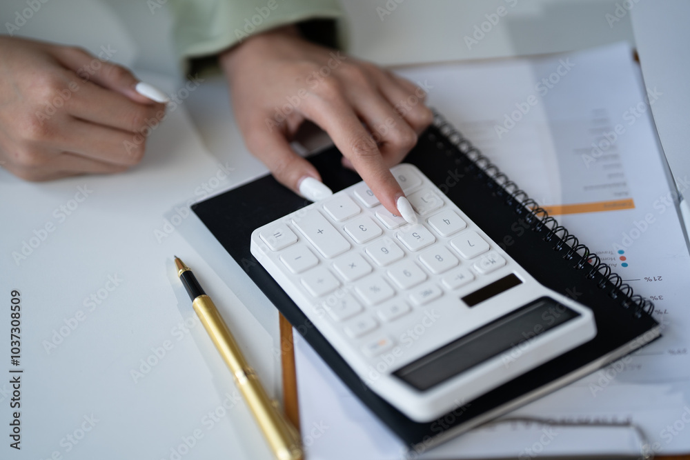 Close-up: Hands Calculating Financial Success: A professional woman's hands meticulously calculate figures on a calculator. Close-up: Hands Calculating Financial Success: A professional woman's hands meticulously calculate figures on a calculator.