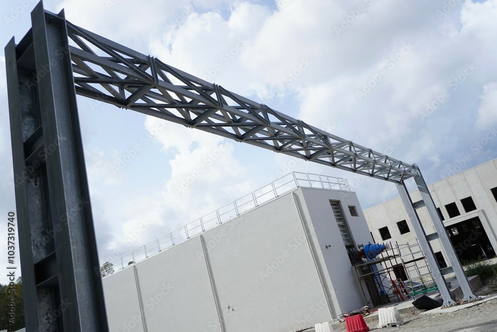 Metal frame with truss. This structure, consisting of steel beams and crossbars, provides stability and support. The metal is coated with a zinc anti-corrosion layer. Metal frame with truss. This structure, consisting of steel beams and crossbars, provides stability and support. The metal is coated with a zinc anti-corrosion layer.