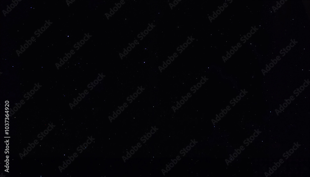 Fototapeta premium Starry night sky in deep black with small scattered stars