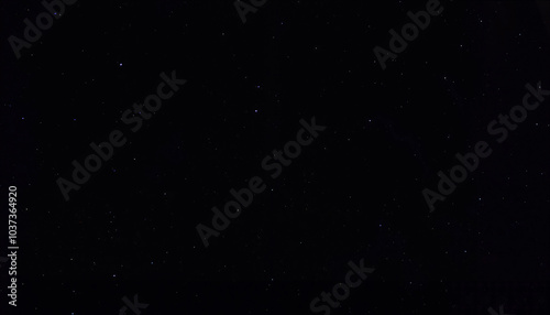 Starry night sky in deep black with small scattered stars