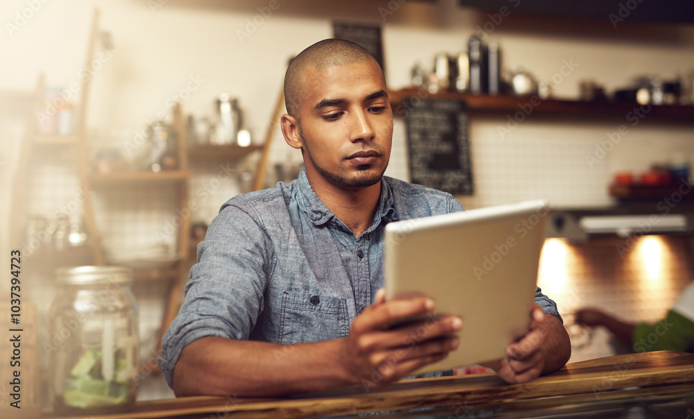 Small business, man and tablet at counter in cafe as manager for online orders, ecommerce and connection. Male person, entrepreneur and serious on internet or website for email and communication Small business, man and tablet at counter in cafe as manager for online orders, ecommerce and connection. Male person, entrepreneur and serious on internet or website for email and communication
