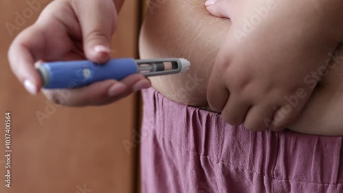A young woman gives an injection to herself