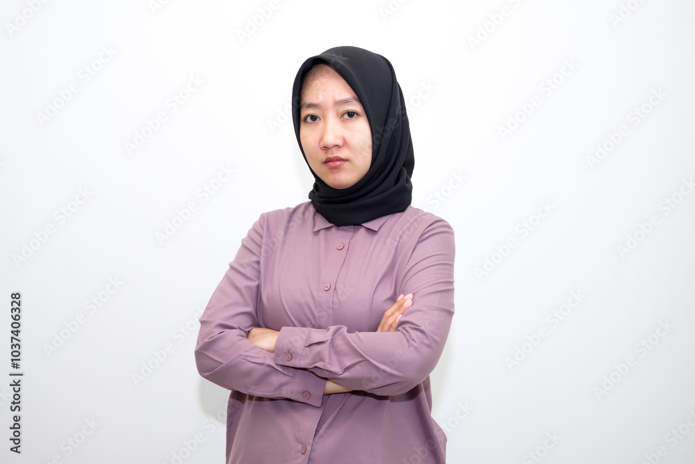 Asian, Indonesian woman wearing purple clothes and black headscarf with angry and upset expression. Her hands are like wanting to scratch, her hands are on her head. isolated in white background