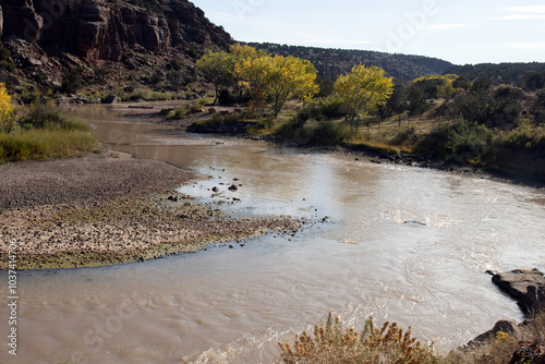 View of the scenic Río Chama, or Chama River, with a cattle fence below Abiquiu Dam in northern New Mexico, USA photo