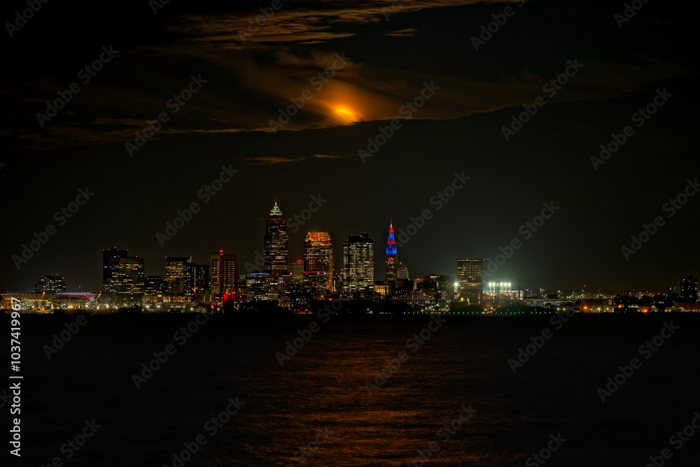 September full moon emerging from clouds over Cleveland, Ohio, and Lake Erie September full moon emerging from clouds over Cleveland, Ohio, and Lake Erie