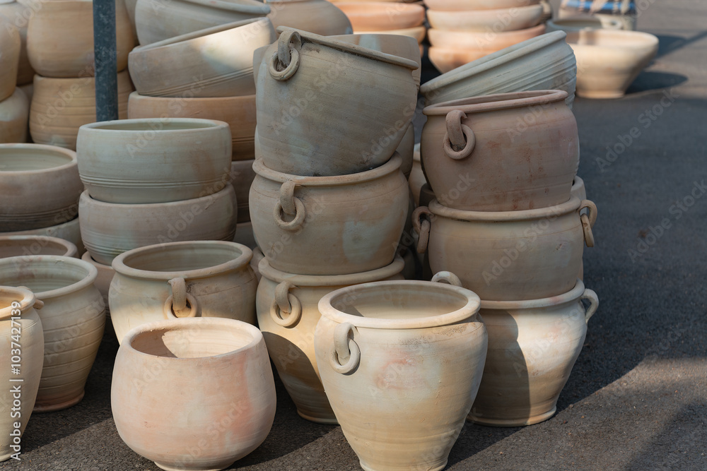 Perfect ceramic pots for trees or flowers. A variety of large clay pots in different shapes and sizes, neatly arranged outside a garden supply store, ideal for gardening and landscaping projects. Perfect ceramic pots for trees or flowers. A variety of large clay pots in different shapes and sizes, neatly arranged outside a garden supply store, ideal for gardening and landscaping projects.