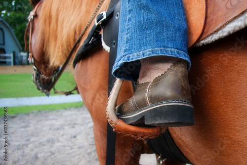 close up of Feet in the stirrup on a horse