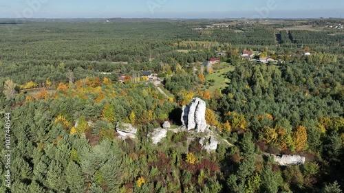 Aerial drone view of Rzedkowice limstone Rocks.Group of rocks in Rzedkowice town. Jurassic limstone rocks in Poland. Jura Krakowsko - Czestochowska, Poland. Limestone rock surrounded by autumn forest. photo