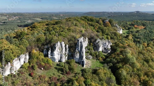 Aerial drone view of Rzedkowice limstone Rocks.Group of rocks in Rzedkowice town. Jurassic limstone rocks in Poland. Jura Krakowsko - Czestochowska, Poland. Limestone rock surrounded by autumn forest. photo