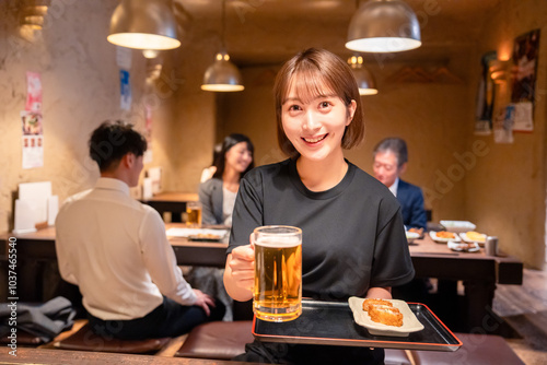 ビールを提供する居酒屋の女性スタッフ photo