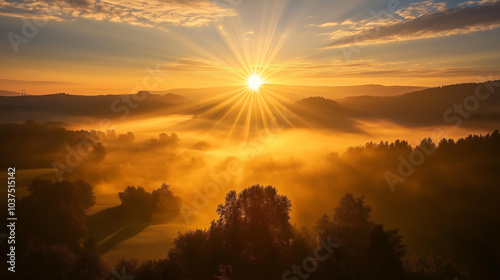 Golden hues paint the sky as the sun dips below the mountain horizon, casting long shadows across the rugged landscape