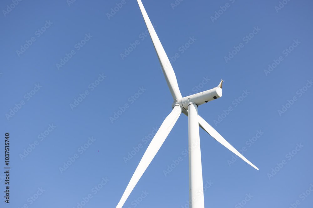 View of wind turbine against blue sky View of wind turbine against blue sky