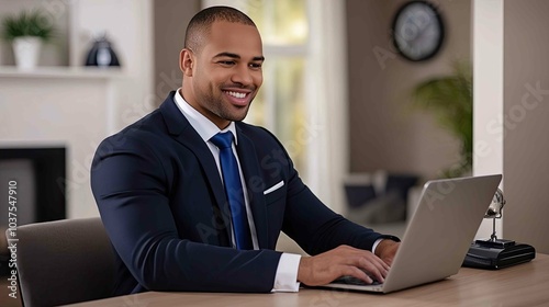 businessman smiling while typing on laptop