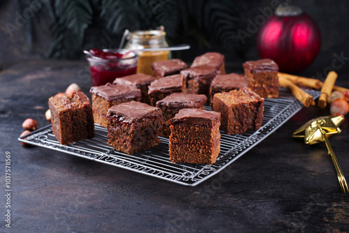 Homemade fudgy brownies domino cake pastry cubes with marmalade and dark chocolate topping glaze photo