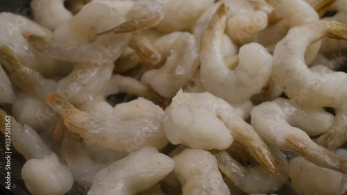  Close-up of cooking big tiger shrimps on the pan.