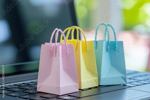 A colorful laptop keyboard with three colorful paper shopping bags. An e-commerce transaction is when you buy or sell goods or services online.